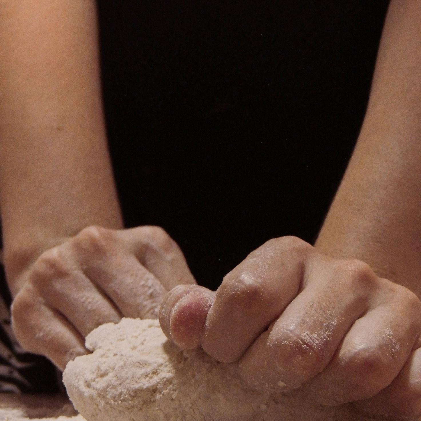 Diverse group of community members sharing a meal together, showcasing the social bonds formed through collaborative cooking
